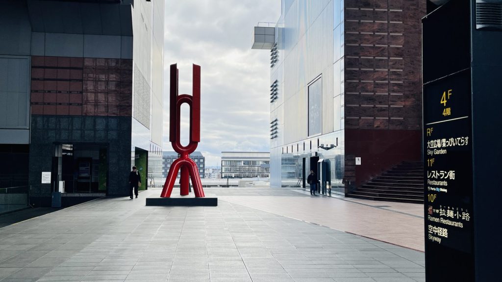 京都駅4階のみんなの広場へ向かう通路に立つ赤いモニュメント